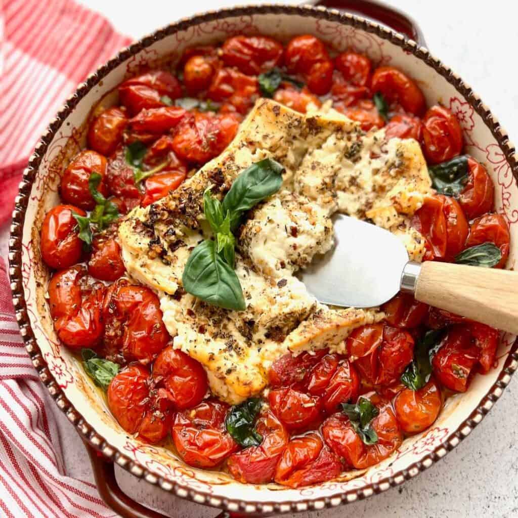 Baked Feta Cheese Dip with roasted tomatoes, garlic and fresh basil.