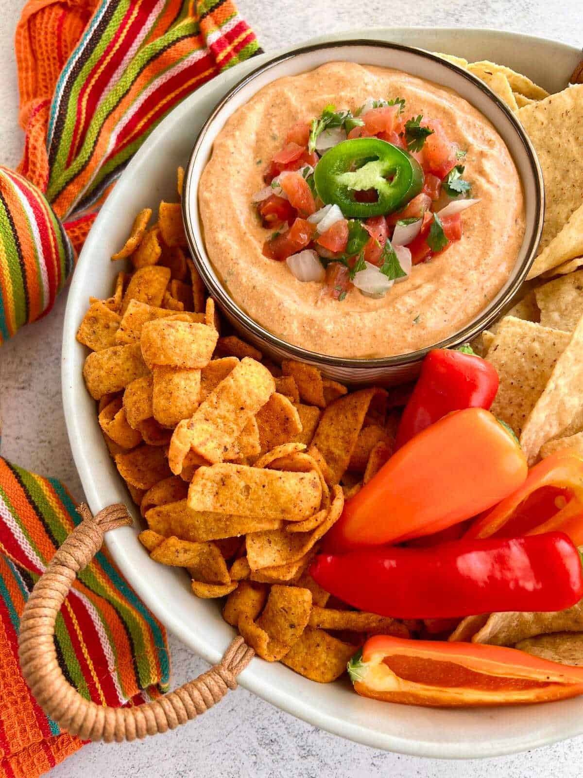 Cottage cheese taco dip surrounded by fritos and tortilla chips