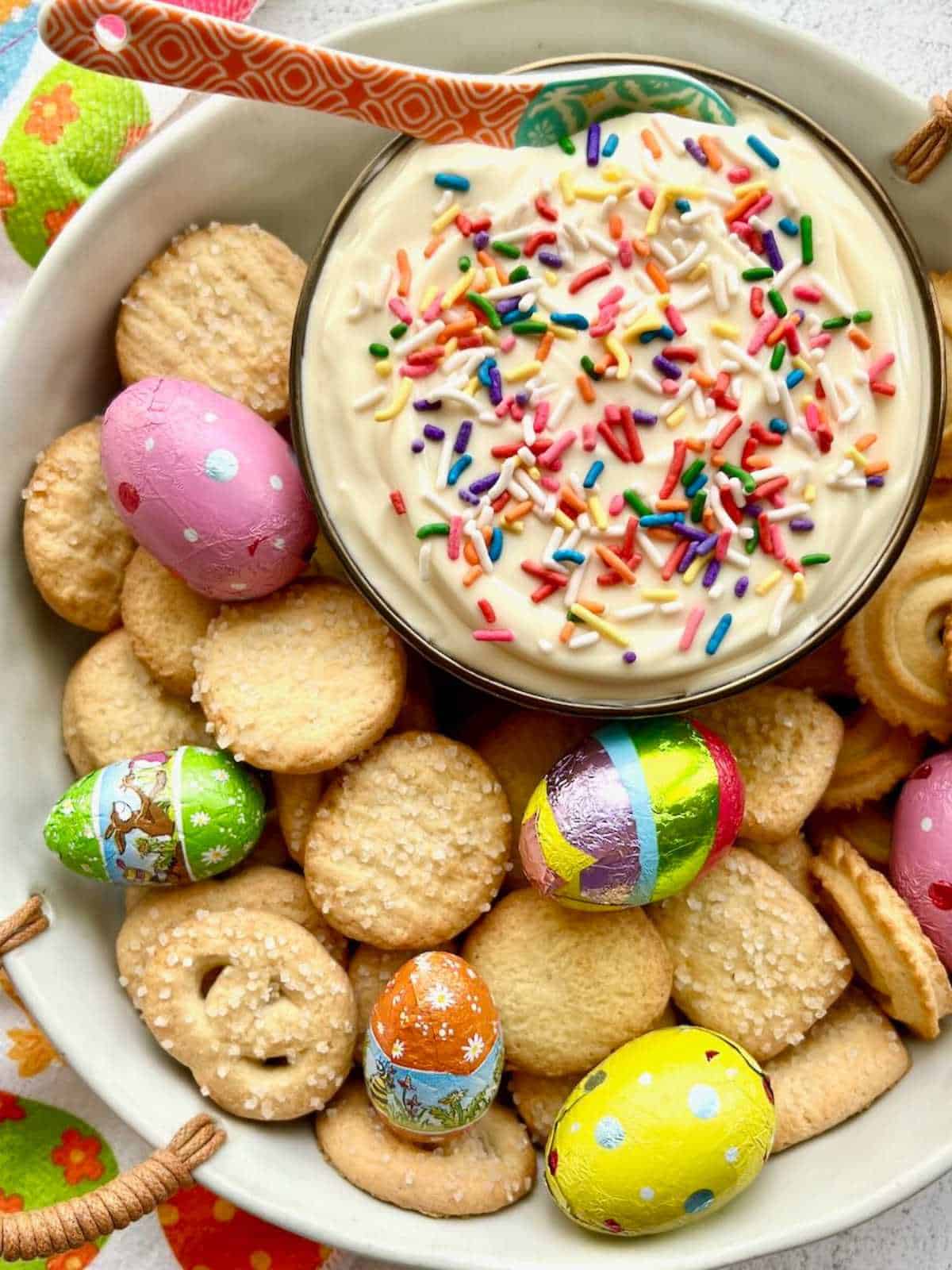 Chocolate Easter eggs and cookies surrounding Easter egg dip.