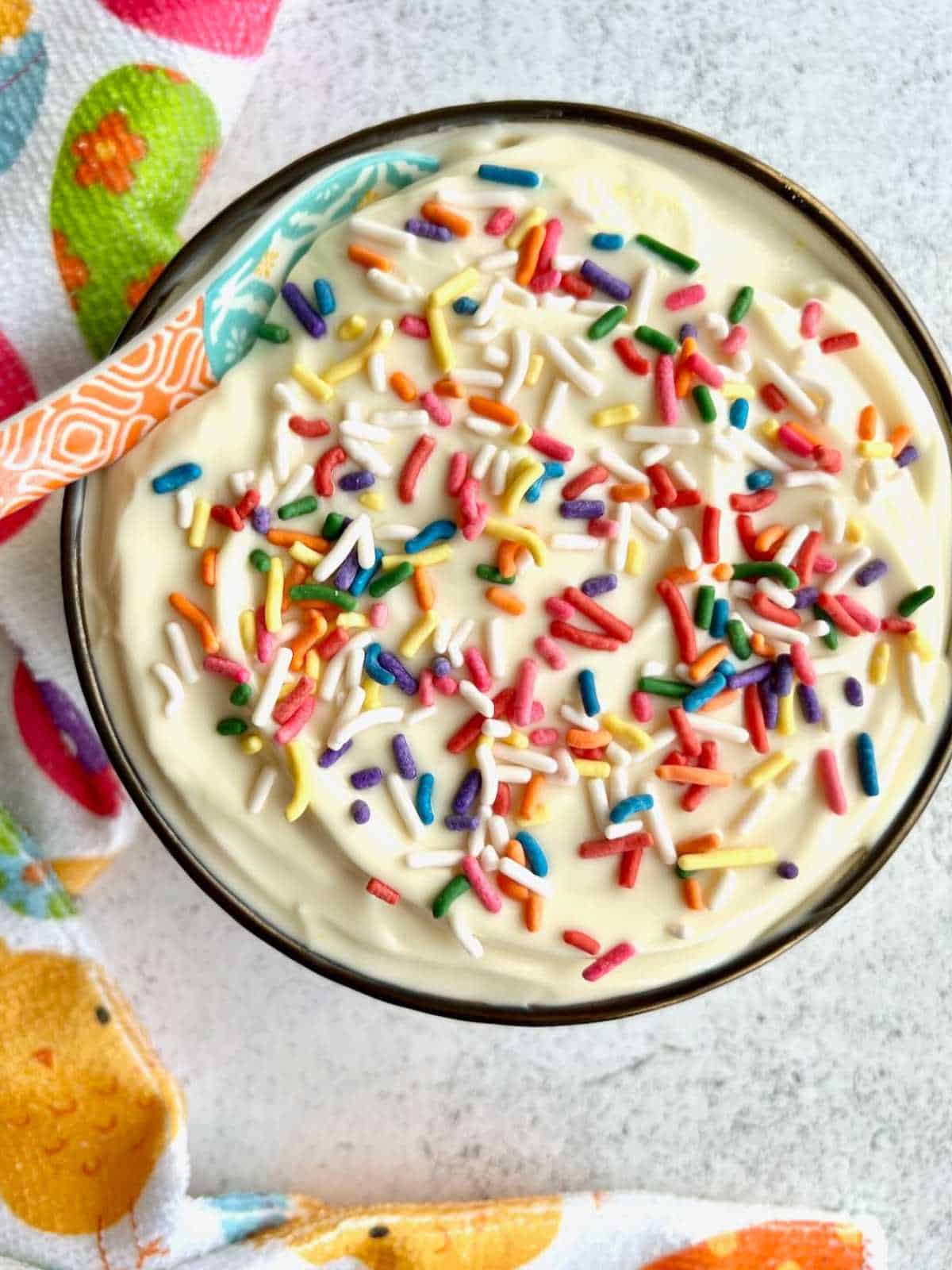 Bowl of Easter egg dip with sprinkles on top.