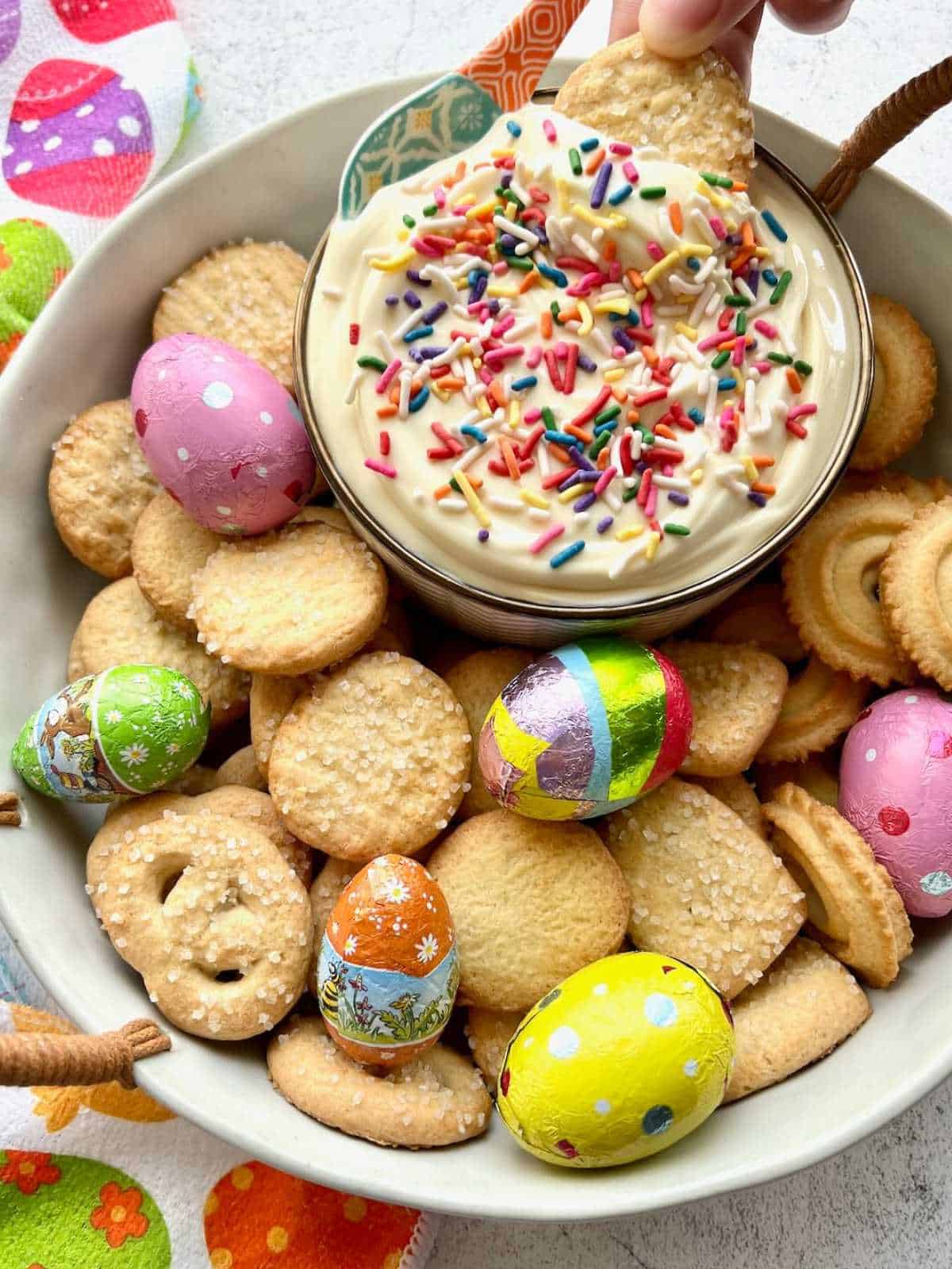 Cookie dipping into Easter egg dip.