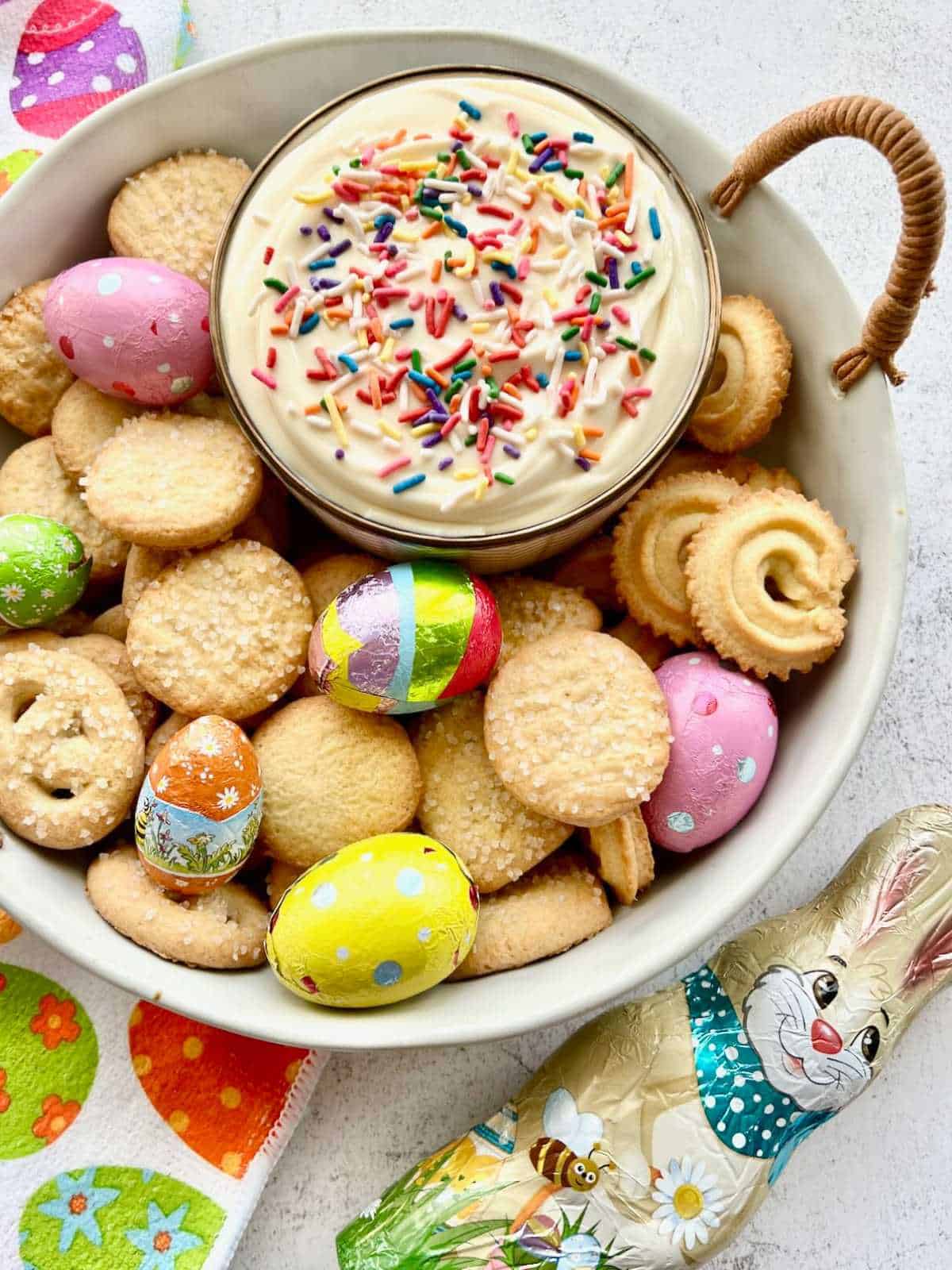 Easter egg dip surrounded by cookies.