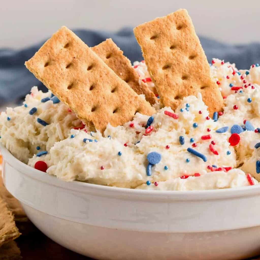 Funfetti cake dip with graham crackers dipped into it.