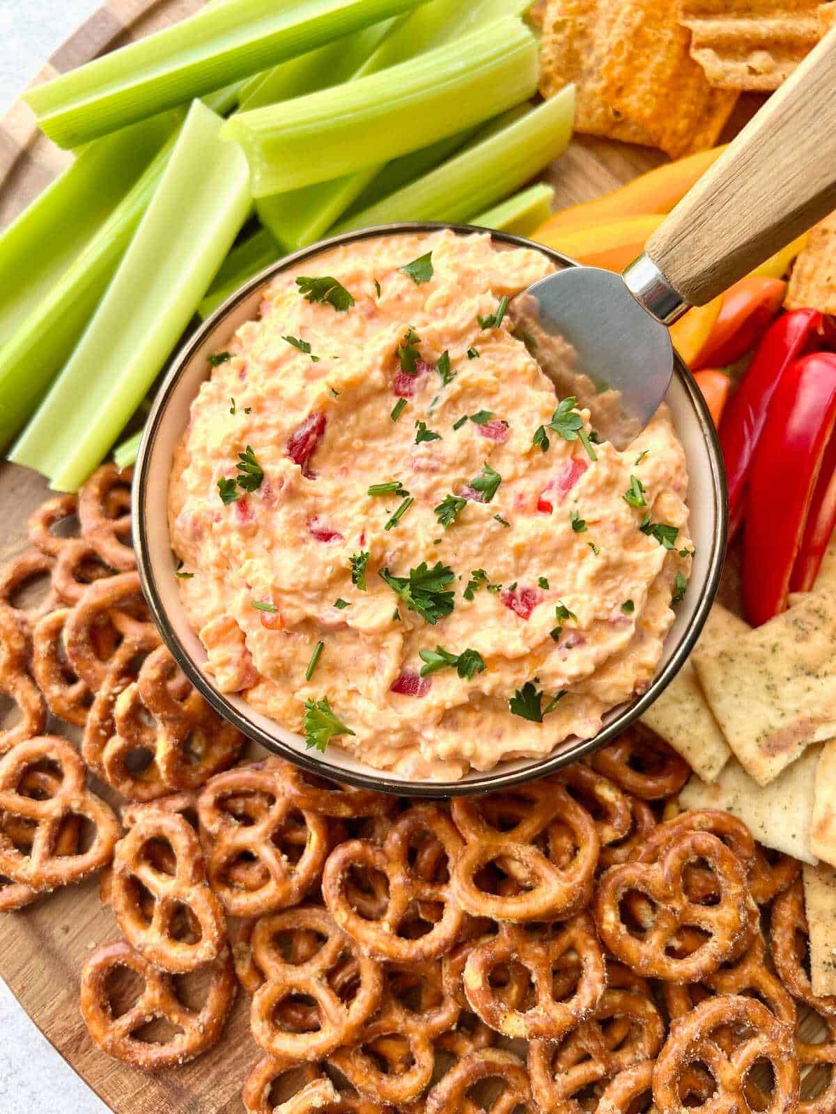 Pimento cheese dip on a dip board.