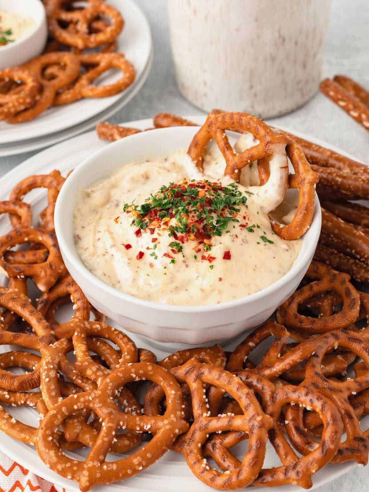 Classic pretzels in a bowl of mustard dipping sauce.
