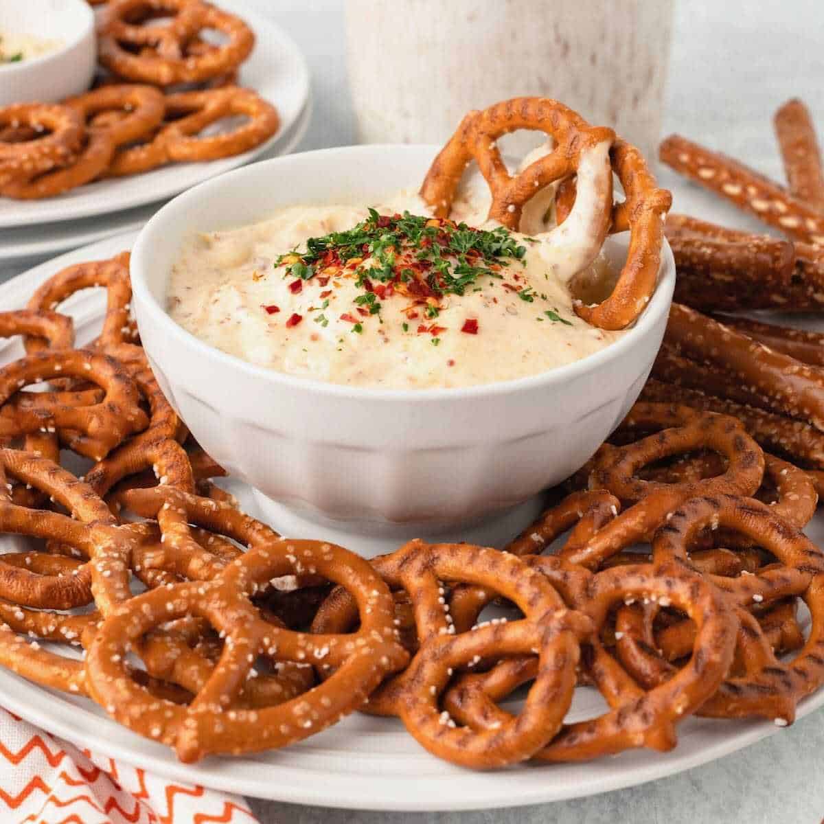 Twisted pretzels dipping into Mustard Dipping Sauce.