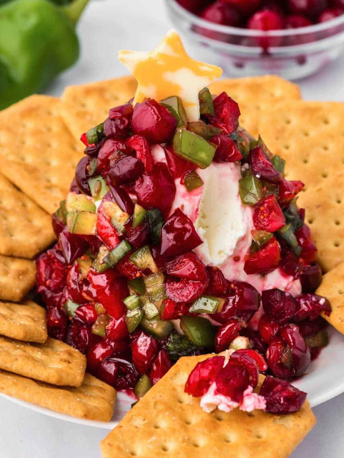 Scoop of Cranberry Jalapeño Dip on a cracker.
