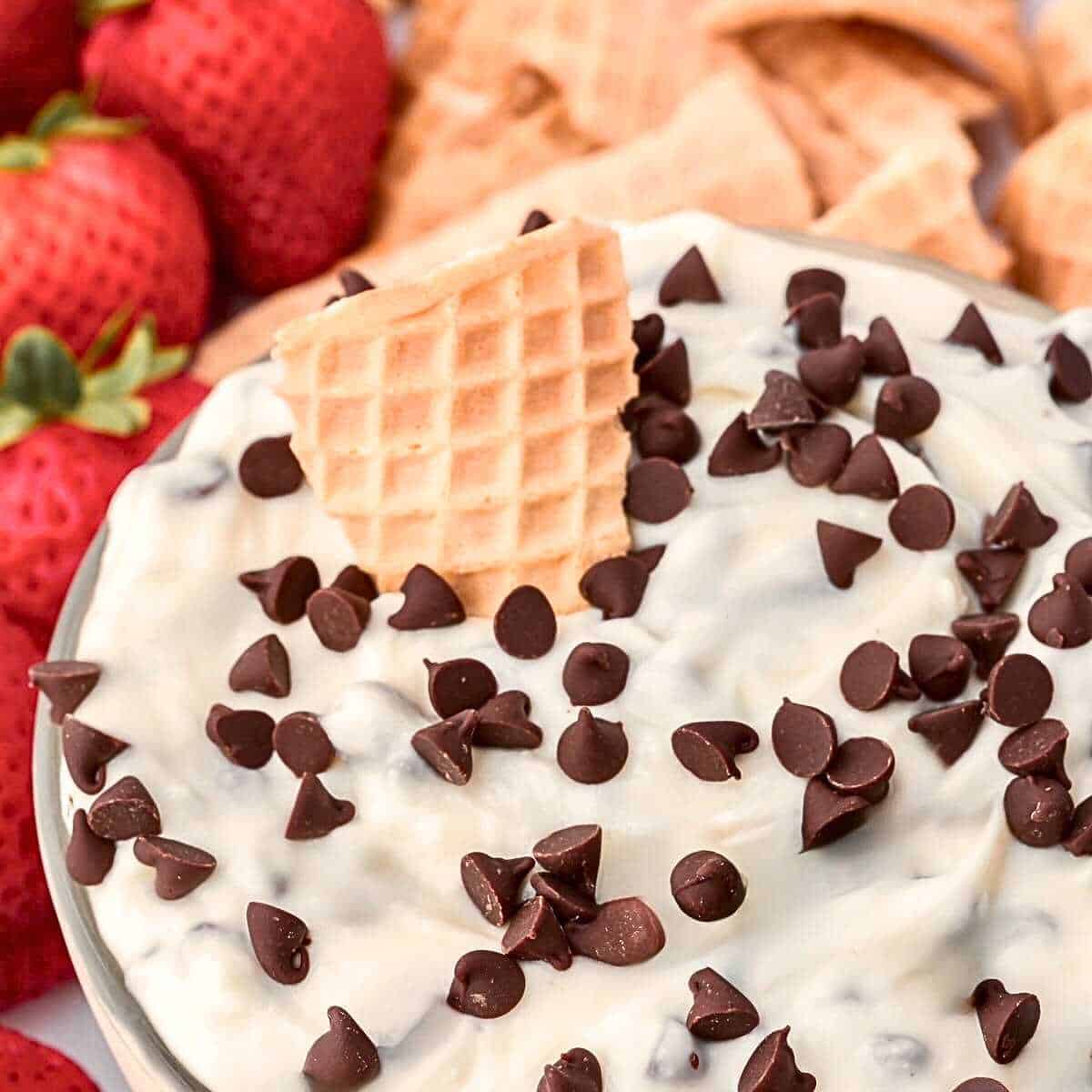 Cannoli dip with a waffle cone chip and strawberries as dippers.