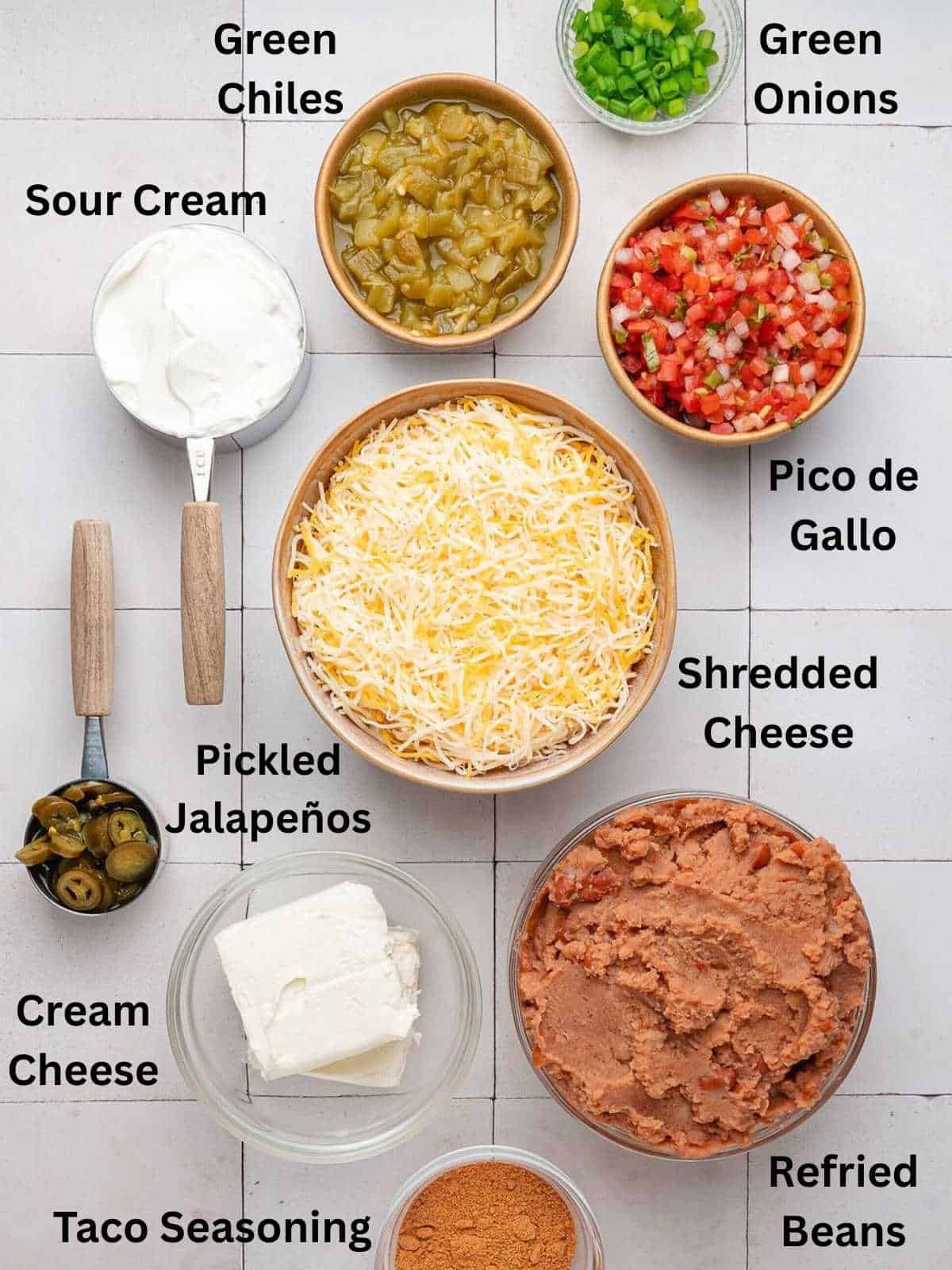 Ingredients needed to make Texas trash dip in various sizes of bowls.