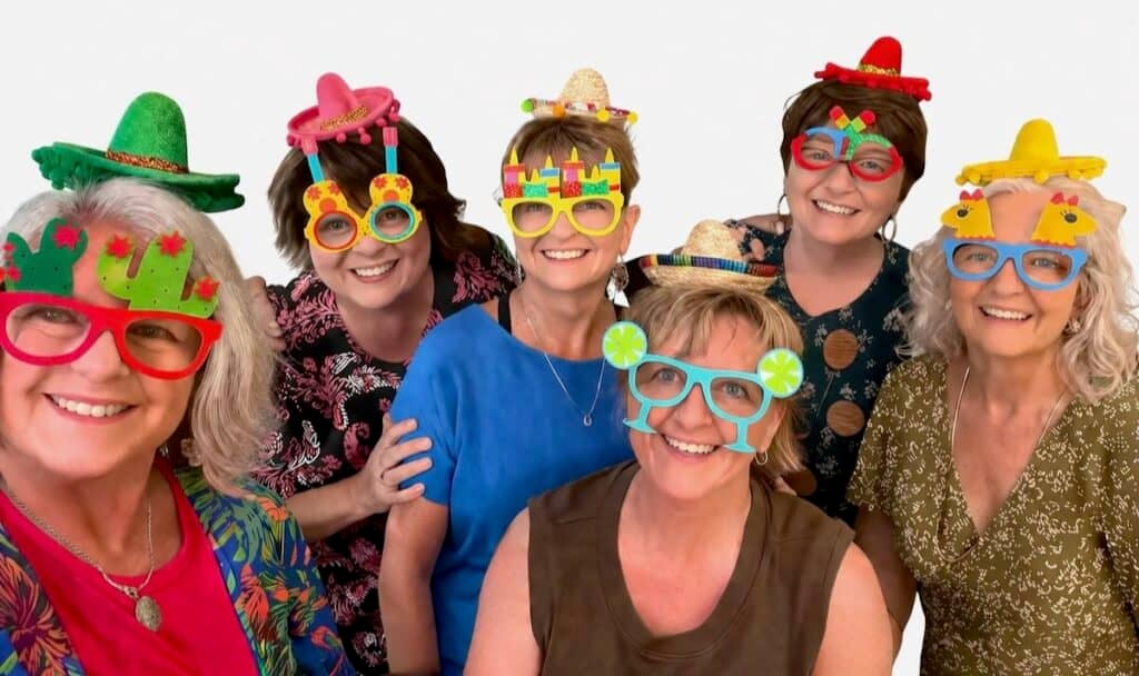 Friends with funny sunglasses and sombreros.