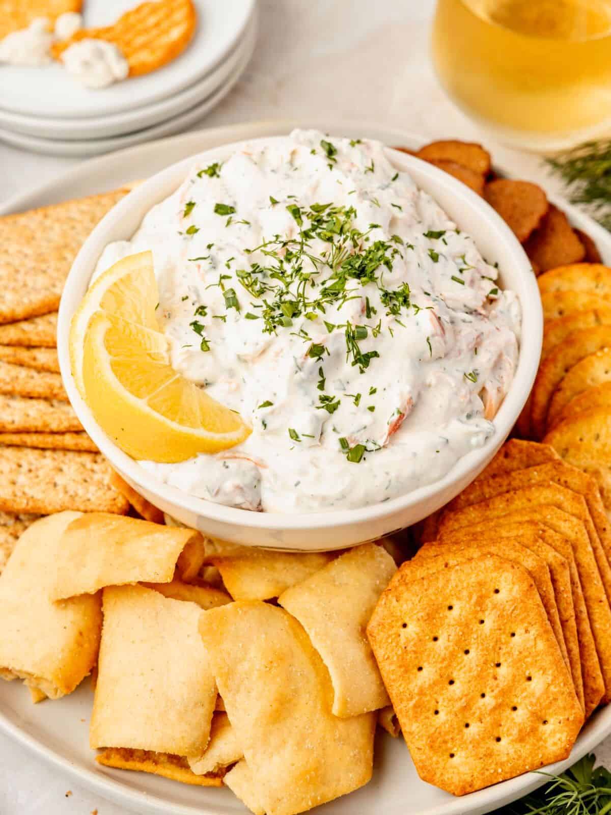 Smoked salmon dip in a bowl with lemon and fresh dill garnish.