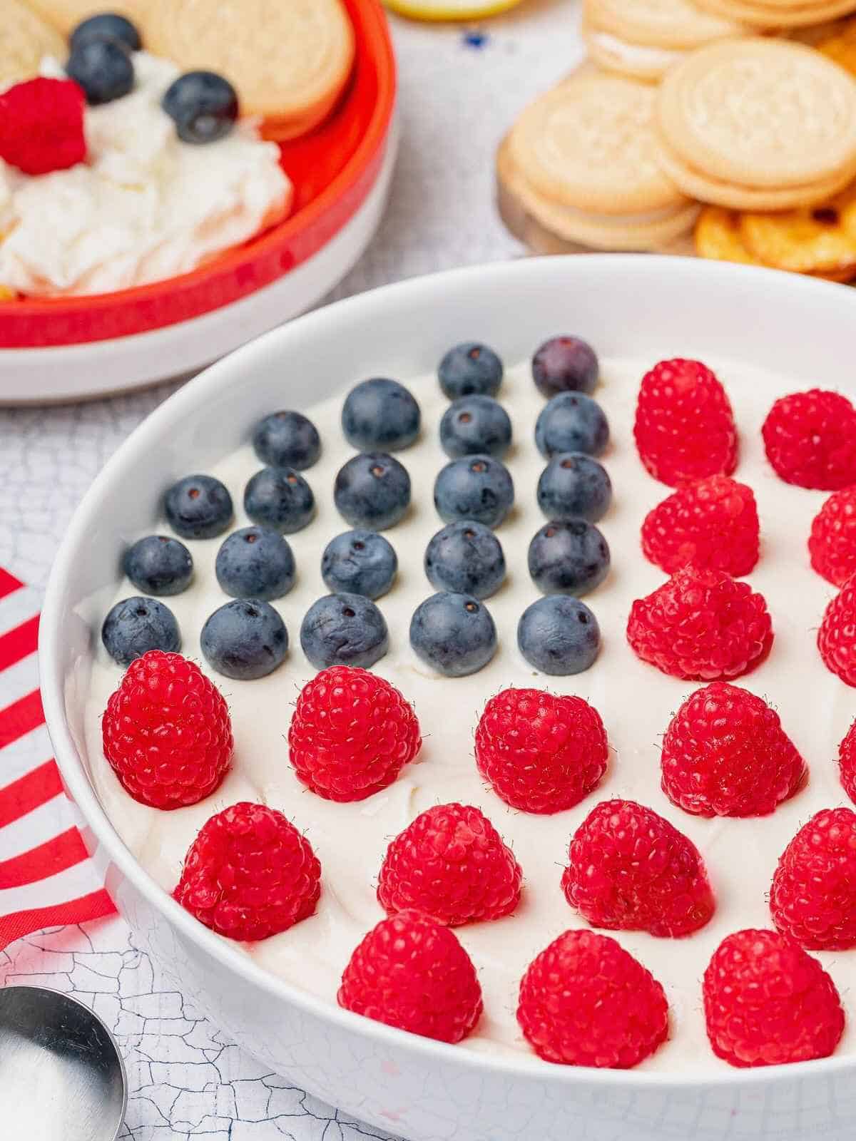 American Flag Dip with raspberries and blueberries on top.