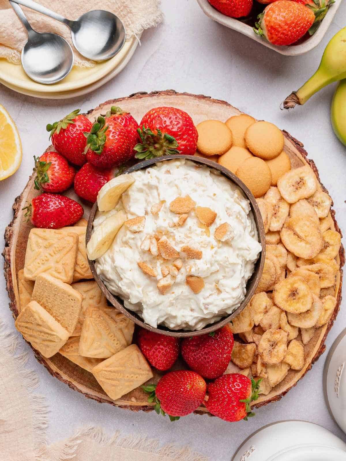 Banana pudding dip board featuring strawberries, Lorna Doon cookies, banana chips and vanilla wafers.