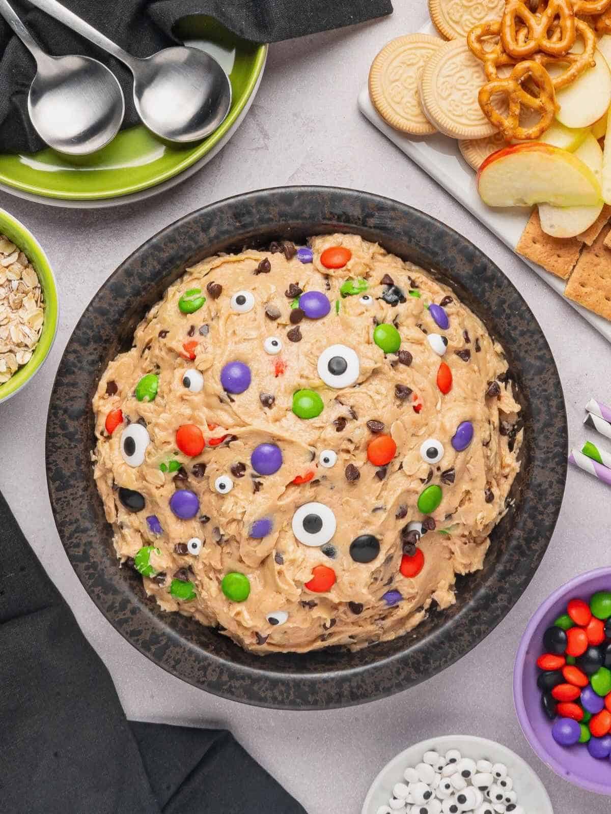 Black bowl of monster cookie dough dip ready to serve.