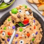 Scoop of Edible Monster Cookie Dough being raised above a bowl.